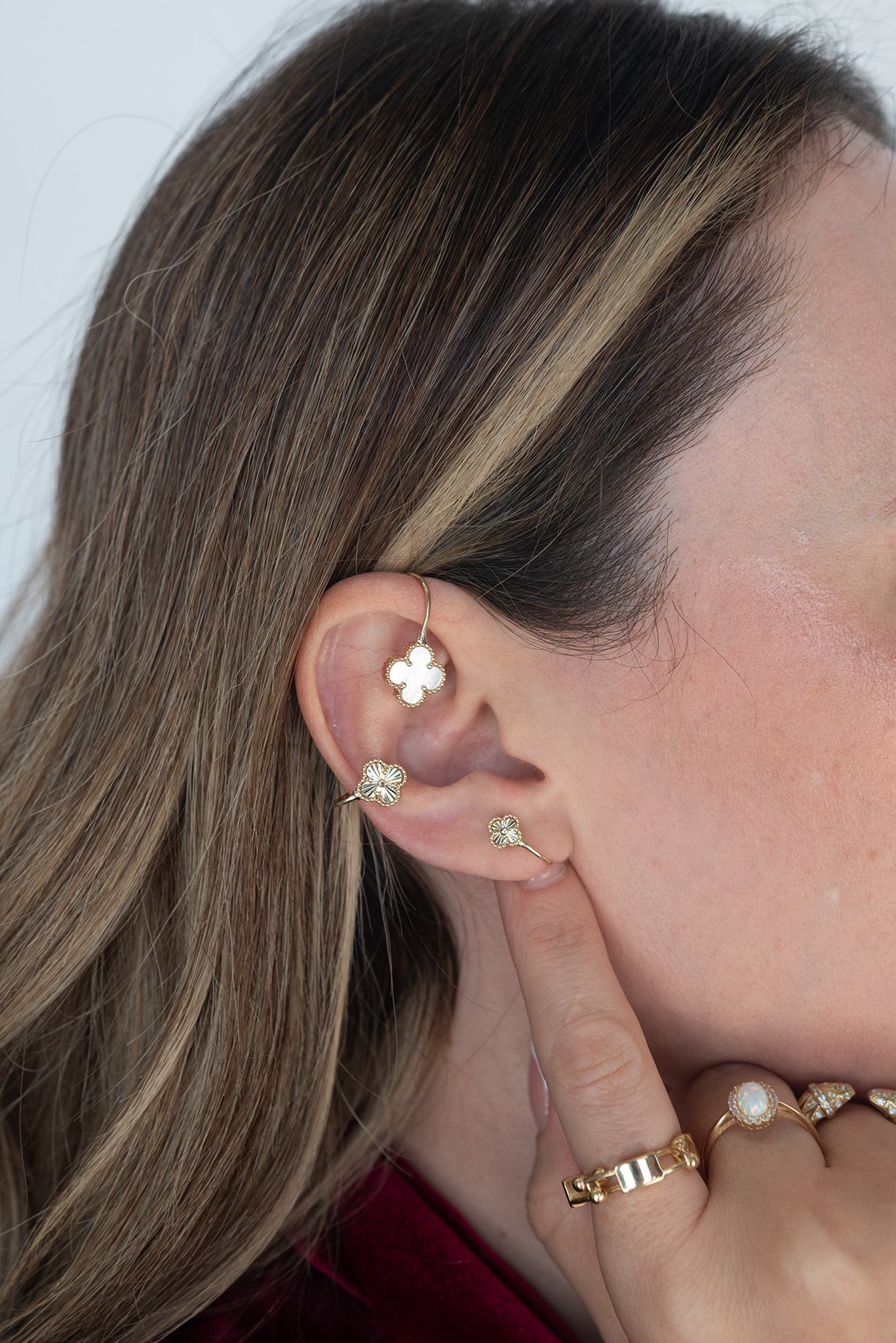 Arete 14 kilates con tres flores de cuatro pétalos decrecientes, madre perla, diamantado y diamantada chica.