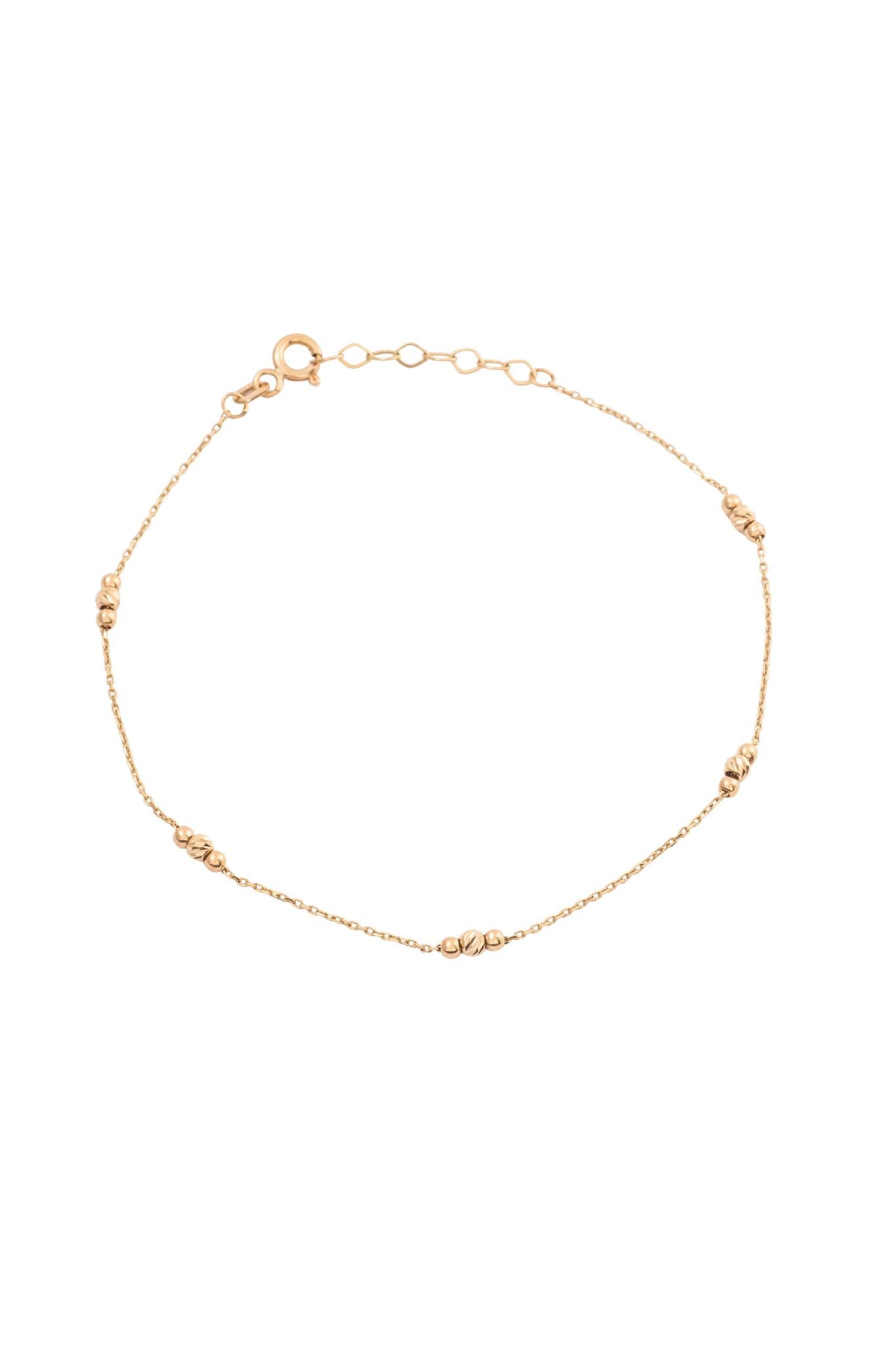 Pulsera 10 kilates con trios bolitas, dos lisas y una central diamantada..png