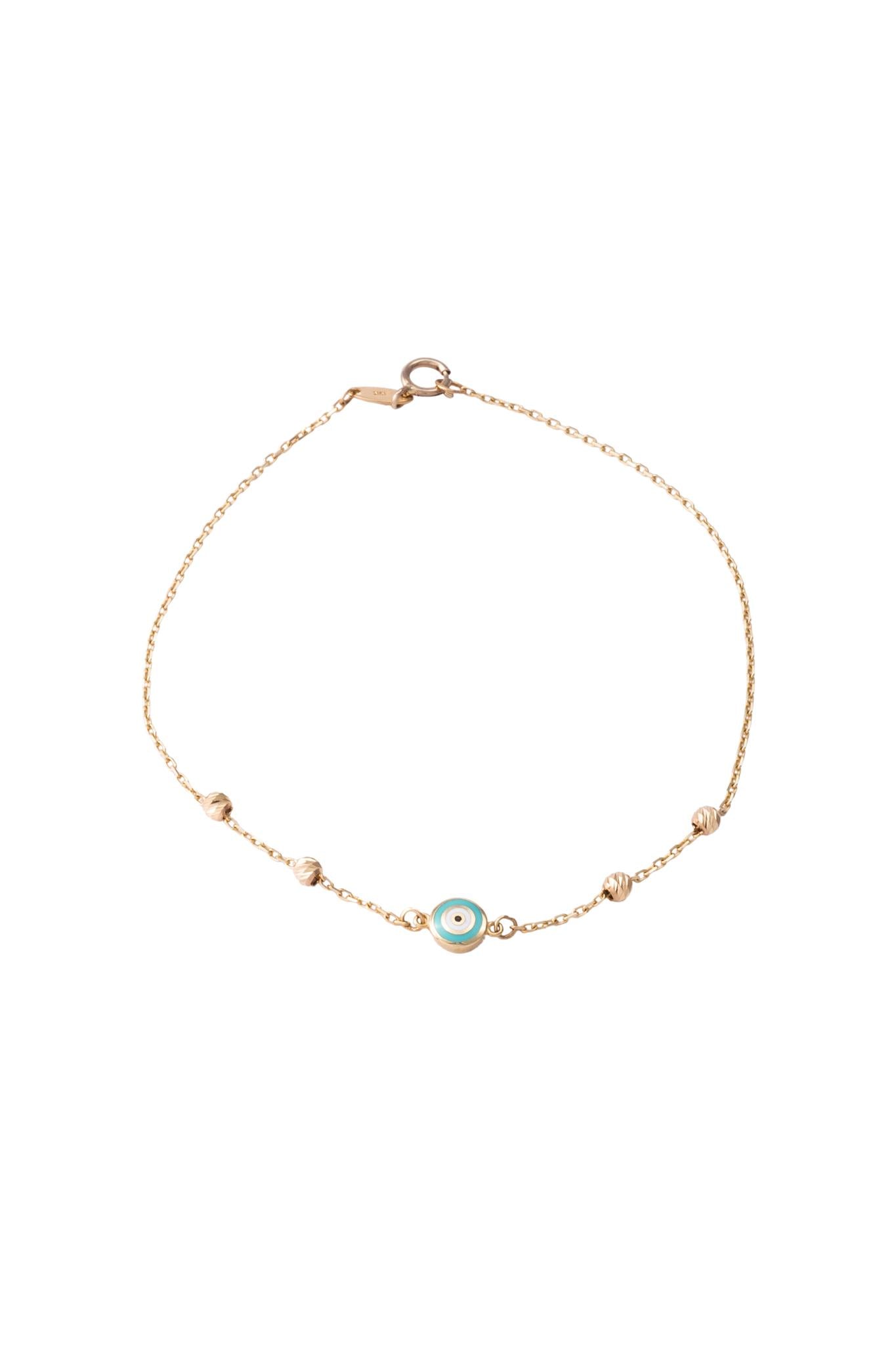 Pulsera de oro sólido en 10 kilates con bolitas diamantadas y ojo circular esmaltado..png