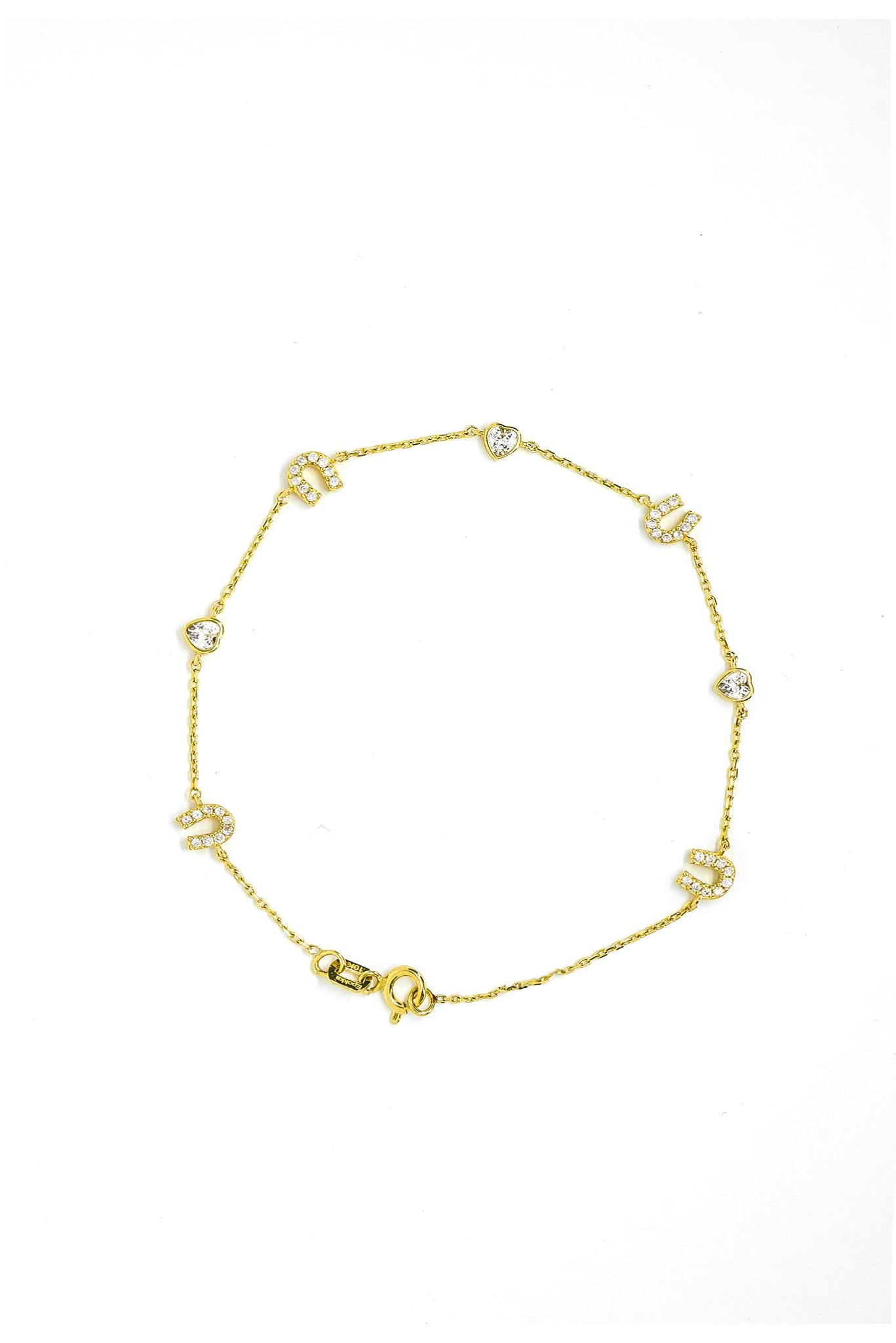 Pulsera de oro sólido en 10 kilates con dijes de herradura y dijes de corazones con zirconia al centro.png