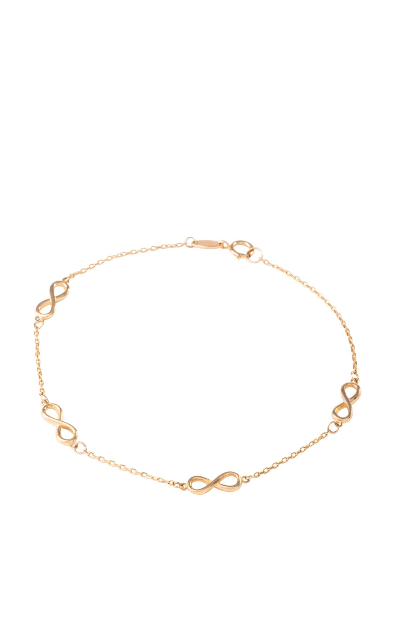 Pulsera de oro sólido en 10 kilates con dijes de infinitos lisos separados..png