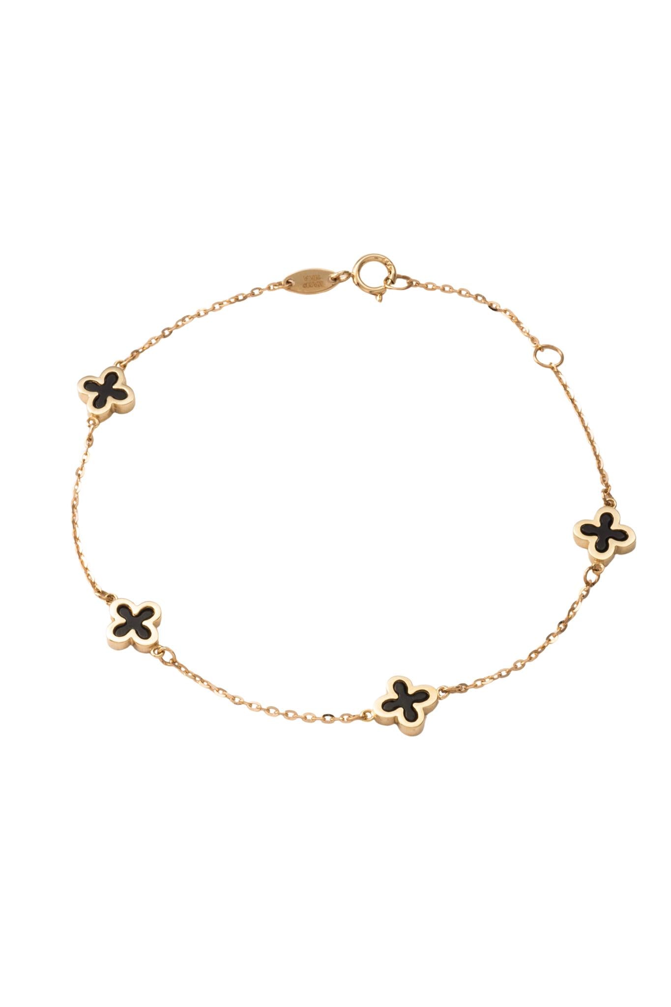 Pulsera de oro sólido en 10 kilates con flores de cuatro pétalos negros onix y bisel liso..png