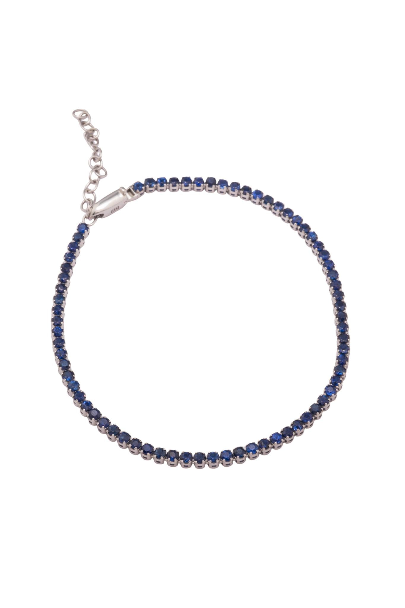 Pulso de oro sólido en 14 kilates con tejido tenis de zafiros de 2.3 cts 15+3 cm montados sobre oro blanco..png