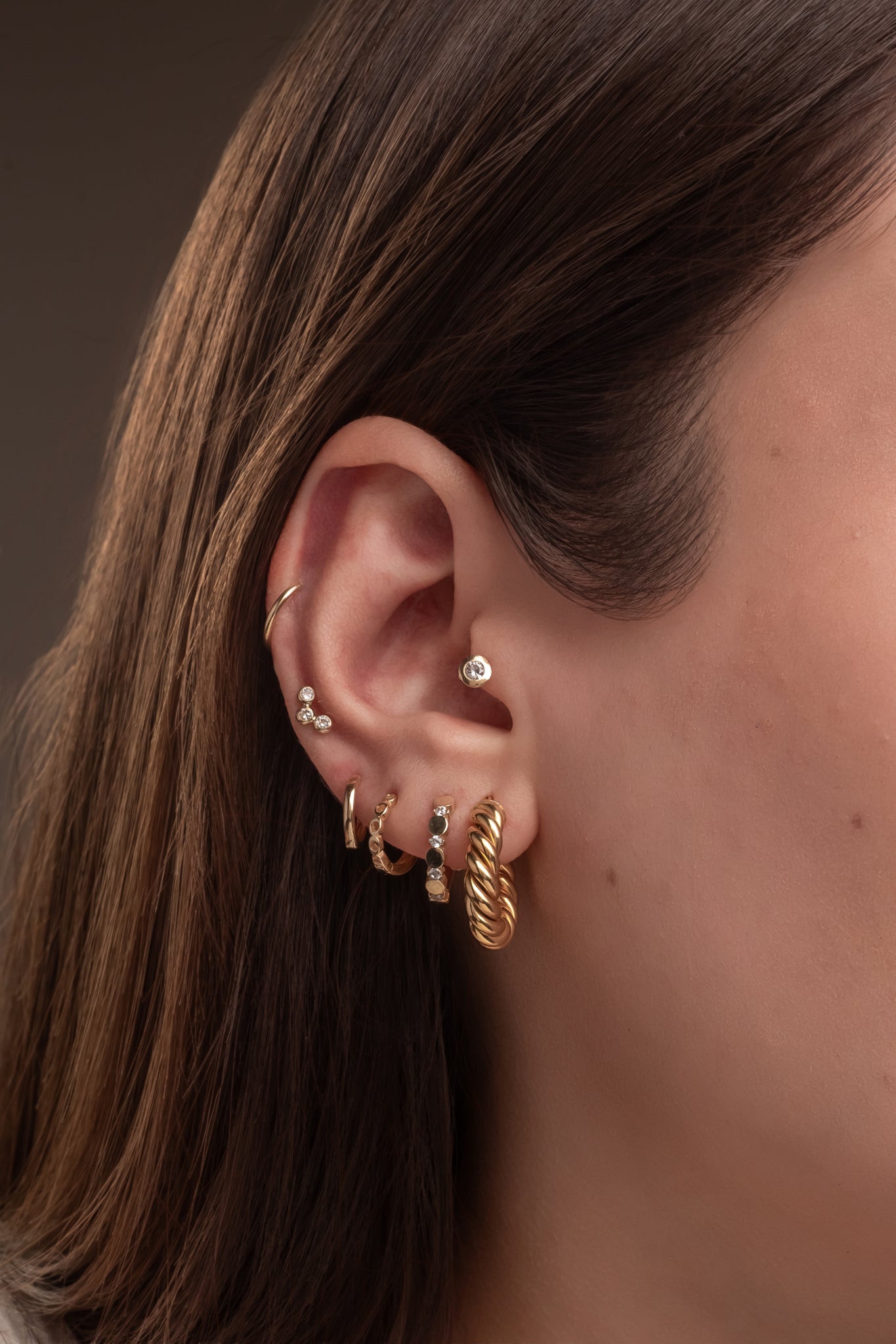 Huggie 10 kilates círculo liso y zirconia intercalados