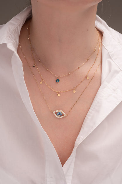 Gargantilla de oro sólido en 10 kilates con dije de ojo de zirconias blamcas, azules y centro zirconia azul grande.