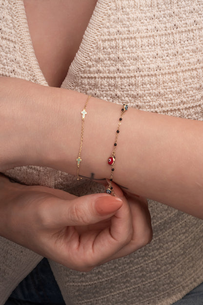 Pulsera 10 kilates bolitas esmaltadas negras y dijes ojos azules y rojo