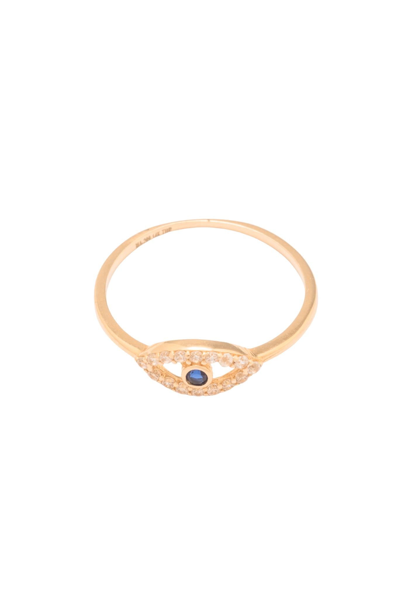 Anillo 10 kilates una silueta de ojo, contorno de zirconia y una zirconia azul rey al centro biselada..png