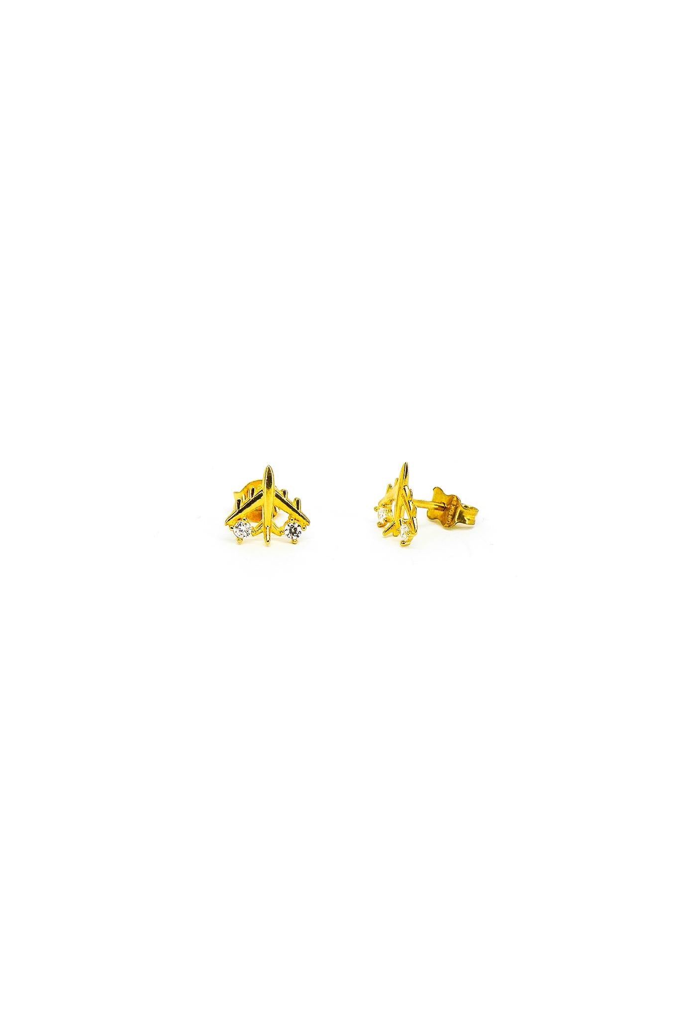 Arete de oro solido de 10 kilates con forma de avion y zirconias a un costado.png