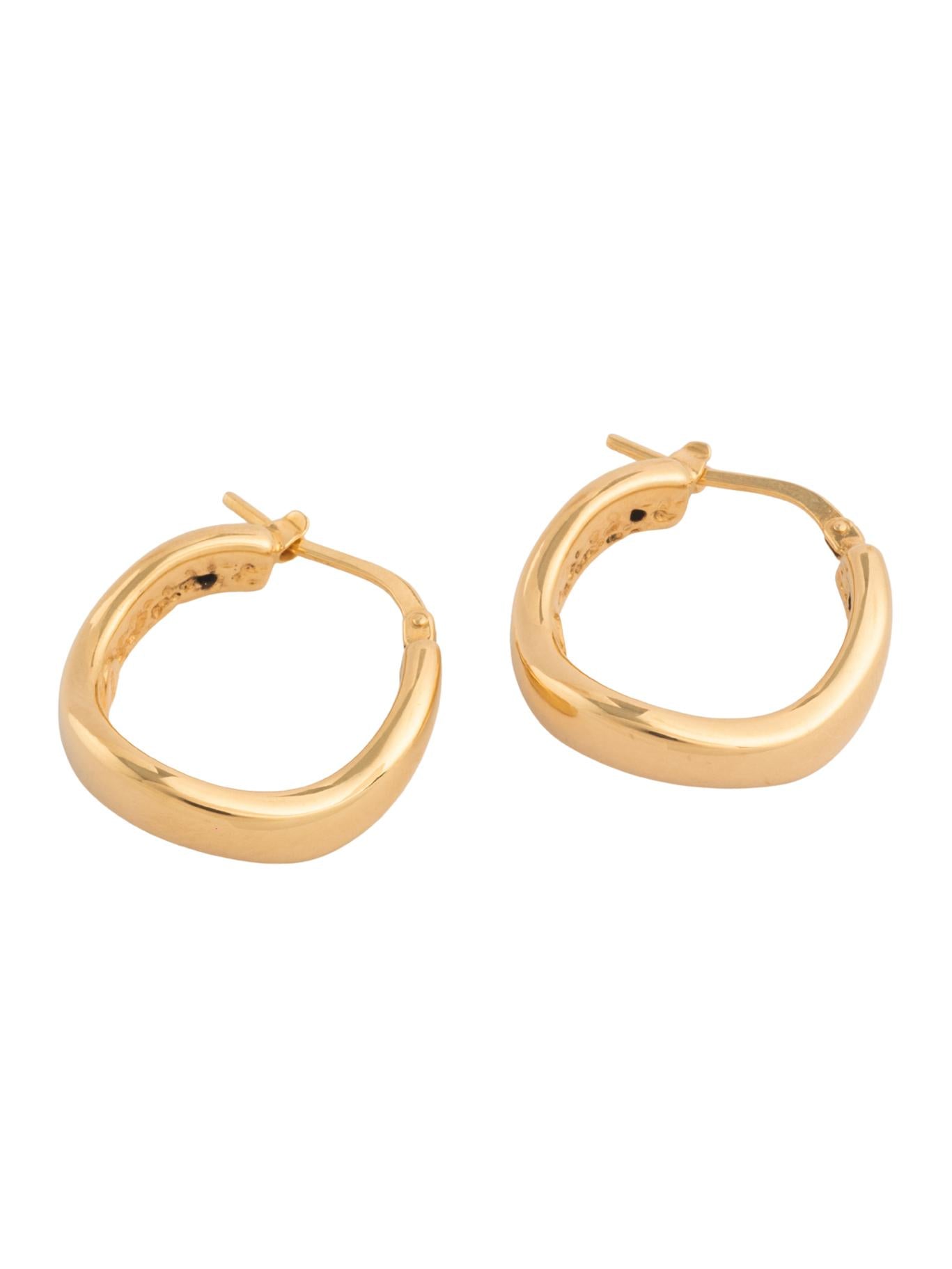 Arracada de oro sólido en 14 kilates con forma de onda lisa inflada..png