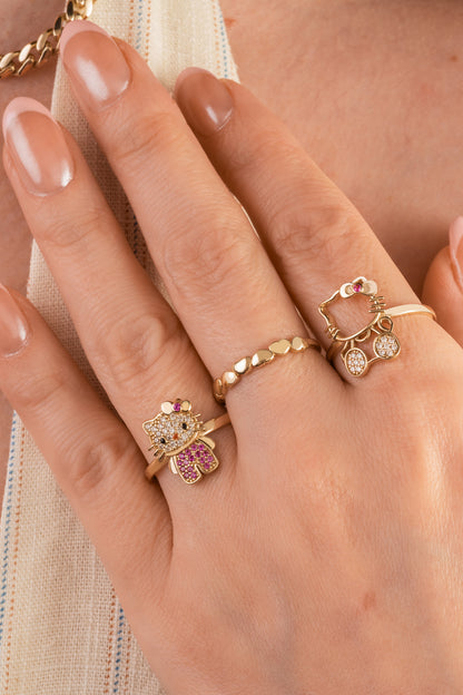 Anillo de oro sólido en 10 kilates con figura de kitty tupida de zirconias en color rosa y blancas.