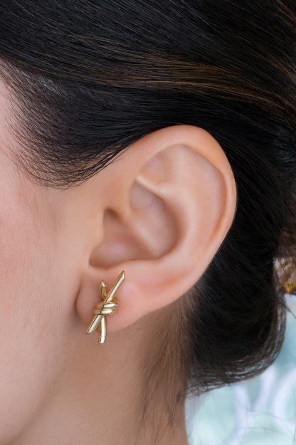 Arete 10 kilates, dos tiras con nudo central liso en oro amarillo.