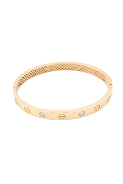 Pulsera aro de oro sólido en 10 kilates con forma de tornillos y zirconias blancas intercaladas..png