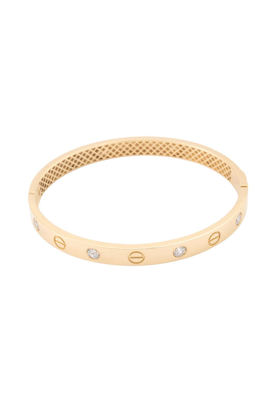 Pulsera aro de oro sólido en 10 kilates con forma de tornillos y zirconias blancas intercaladas..png