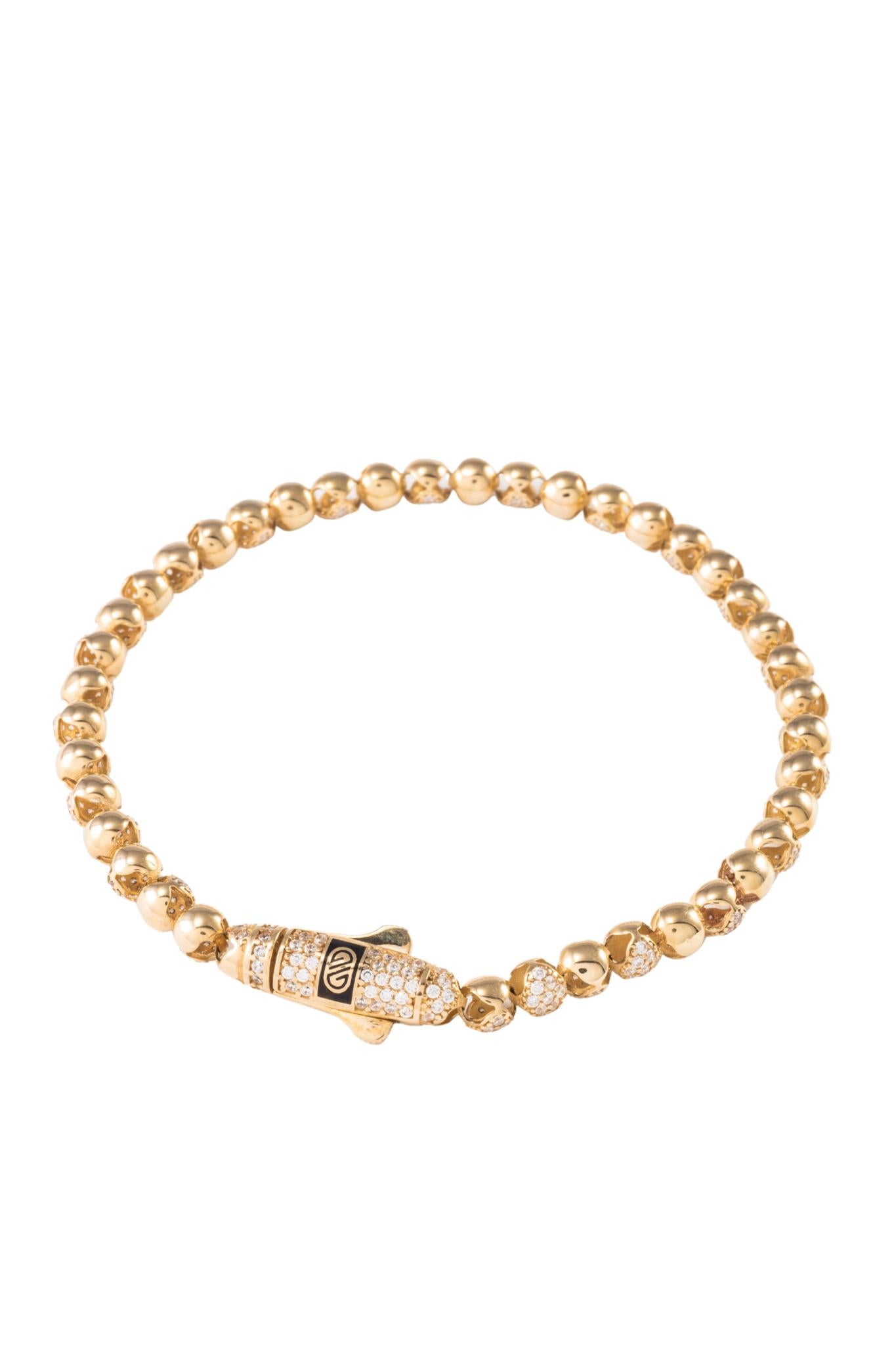 Pulsera de oro sólido en 10 kilates con dijes de bolas huecas lisas y zirconias intercaladas..png