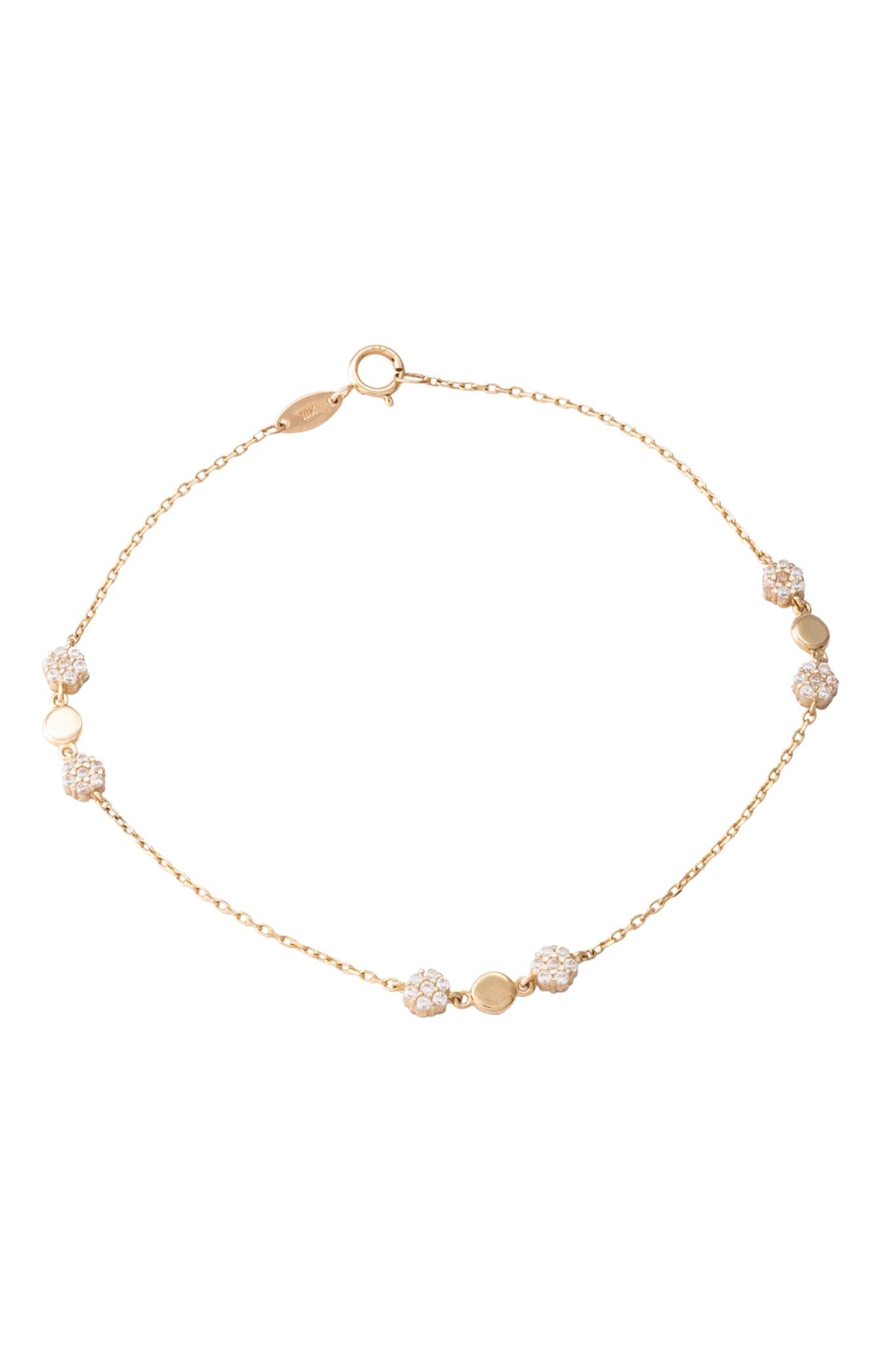 Pulsera de oro sólido en 10 kilates con flores zirconias y un círculo liso al centro.png