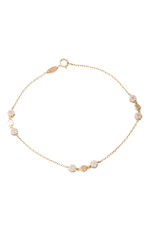 Pulsera de oro sólido en 10 kilates con flores zirconias y un círculo liso al centro.png