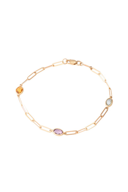 Pulso de oro solido en 10 kilates con un eslabón cuadrado con tres piedras de colores pastel.png